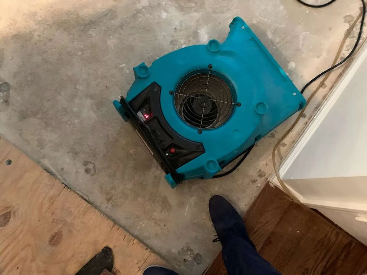 Air mover drying subfloor during Commercial Water Damage Restoration in Enid